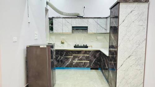 cocina con encimeras de mármol y fregadero en Orchid Highland, en Dehradun