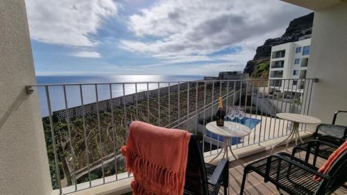a balcony with a view of the ocean at Pearl Retreat by Holiday Rental Madeira in Câmara de Lobos