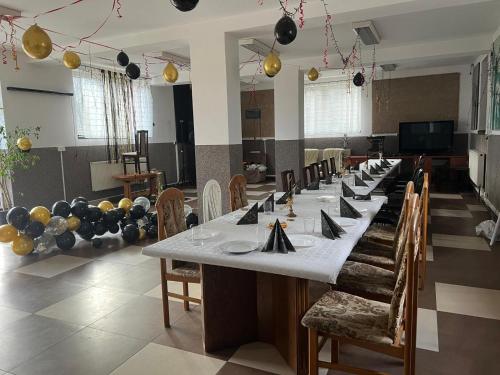 una grande sala da pranzo con un lungo tavolo e sedie di Agroturystyka-wypoczynek 