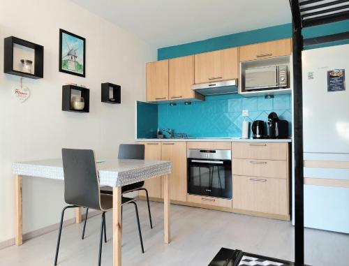勒克鲁西克Studio Emma的房间里有一张桌子和几把椅子的厨房