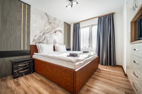 a bedroom with a large bed in front of a window at Best Central Lux Studio in Bansko