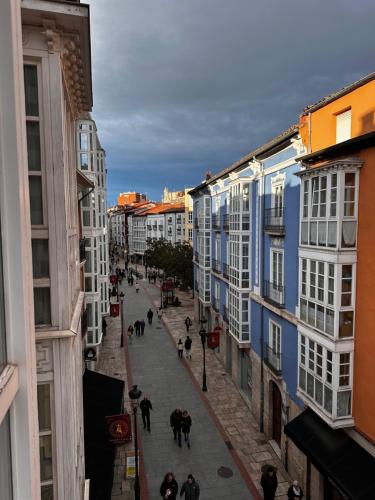 a group of people walking down a street with buildings at Atuaire Home Centro Histórico con vistas rozando la Catedral con Parking Incluido in Burgos