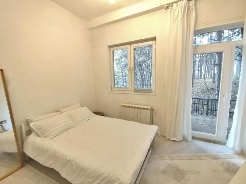 a bedroom with a bed and a window at Central Pristina Park-Side Home in Pristina