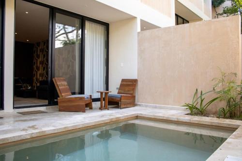 图卢姆Peregrina Tulum 102A 2BR Luxury Condo的房屋旁带游泳池的房子