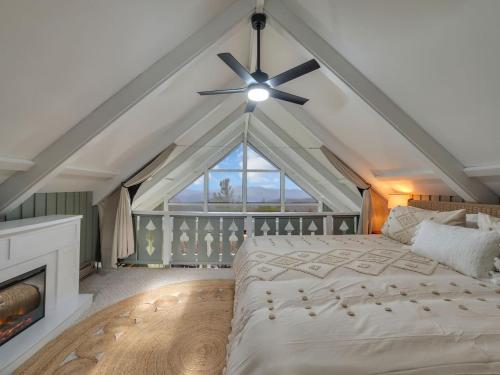 a bedroom with a white bed and a ceiling fan at Lookout Lodge in Beech Mountain