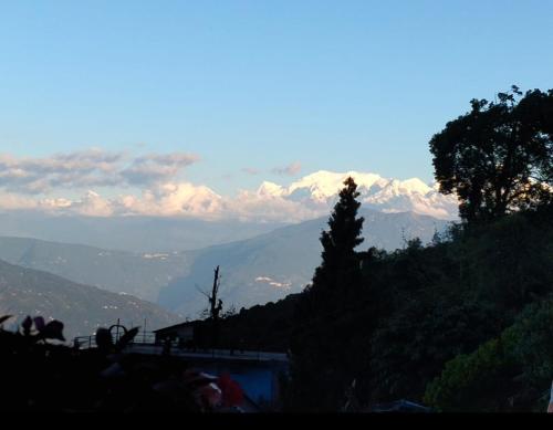 a view of a mountain with snow capped mountains at Susanta Homestay , Icchegaon , Kalimpong in Kalimpong