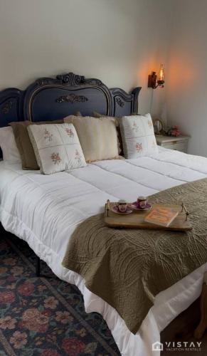 a large bed with a tray on top of it at The Wandering Doe Readers Retreat with Hot Tub in Long Valley Junction