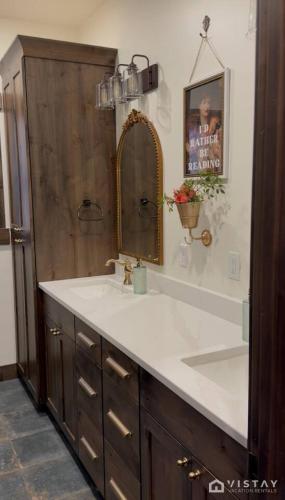 a bathroom with a sink and a mirror at The Wandering Doe Readers Retreat with Hot Tub in Long Valley Junction