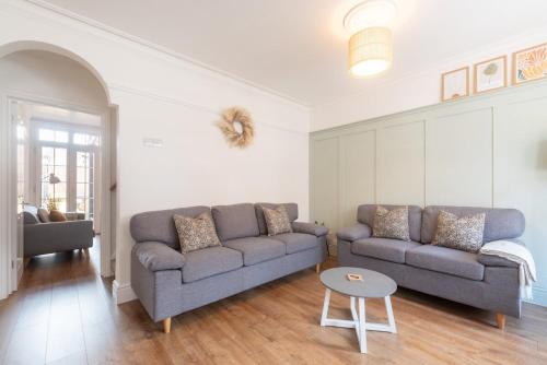 a living room with a couch and a table at Westfield Town-House Free Parking, Secure Garden in Caversham