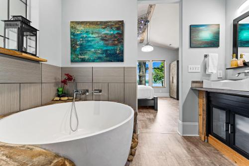 a bathroom with a tub and a sink at Nancy Key w/Pool, Wine Cave, Optional Boat Rental in Denver