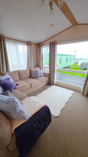 a large living room with a couch at 17 Ruby Atlas Monreith in Monreith