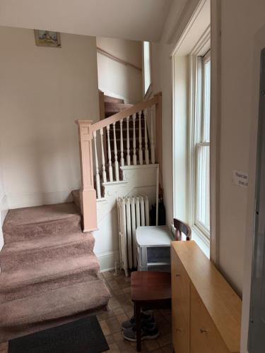a staircase in a house with a stair case at Pleasant Rooming House in Washington
