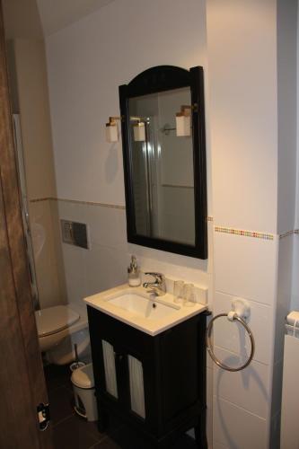 a bathroom with a sink and a mirror at La Cantina del Tobero in Fuentetoba