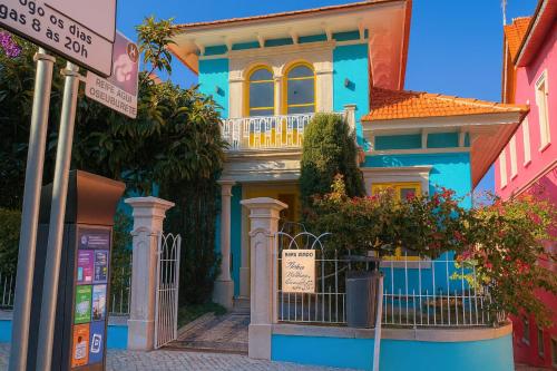 a blue house with a balcony on a street at Happy Holiday Sintra in Sintra