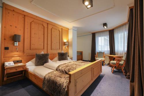 a hotel room with a bed and a desk at Chalet Madlein in Ischgl