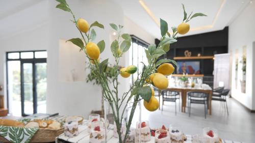 a vase filled with oranges on top of a table at Adamsgarth Guesthouse Hout Bay in Cape Town