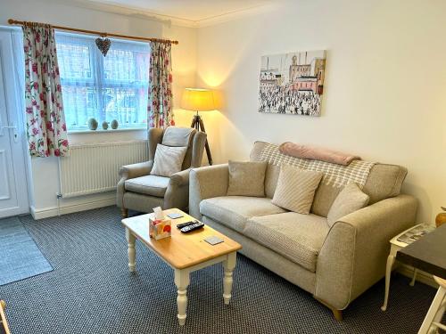 a living room with a couch and a table at Modern 2 Bedroom Ground Floor Apartment with Parking Ripon City Centre in Ripon
