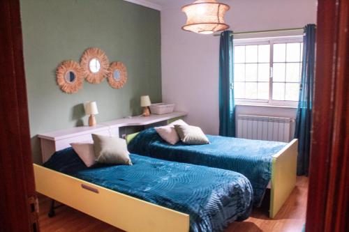 Postel nebo postele na pokoji v ubytování D'Ouro Meu House