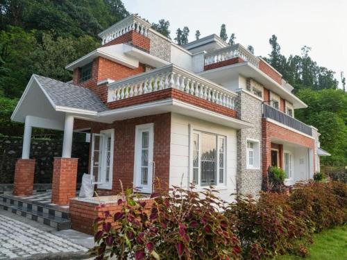 KandogalThe Chirping Sal Villa, by ShivStuti HomeStays的砖屋,上面设有阳台