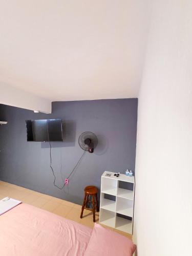 a bedroom with a bed and a tv on the wall at Habitación estándar tancitaro in Oaxaca City
