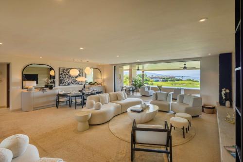 a living room with white furniture and a large window at Ocean view Escape Private Plunge Pool Concierge in Punta Mita