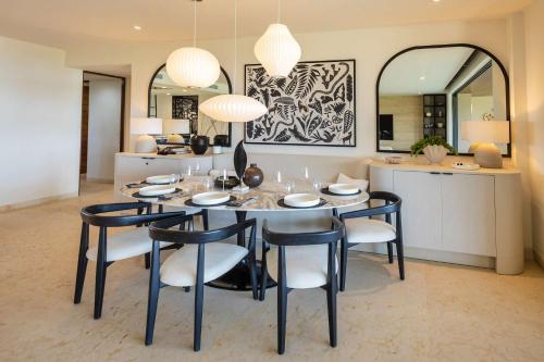 a dining room with a table and chairs and a mirror at Ocean view Escape Private Plunge Pool Concierge in Punta Mita