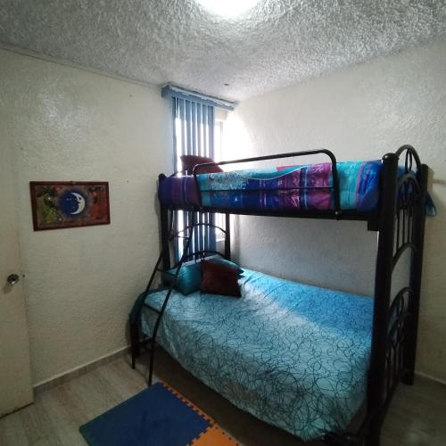 Ένα ή περισσότερα κρεβάτια σε δωμάτιο στο Departamento en Condominio Rocasol