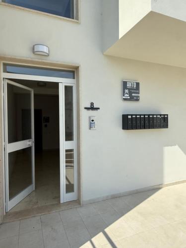 an open door to a building with a sign on it at ANTO Wellness & Suite in Nova Siri Marina