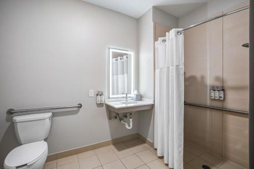 a bathroom with a toilet and a sink and a shower at Holiday Inn Express & Suites Jacksonville - Atlantic Beach by IHG in Jacksonville