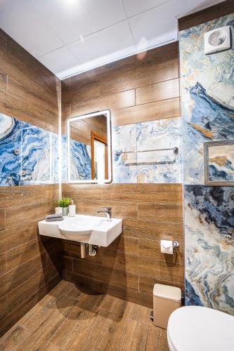 a bathroom with a sink and a mirror at Best Central LUX Studio in Bansko