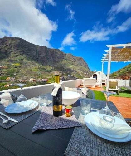 a table with a bottle of wine and glasses at Casa Lara in Hermigua