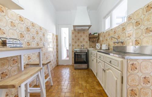 a kitchen with a sink and a stove top oven at Abrotea Apartments in Lagos