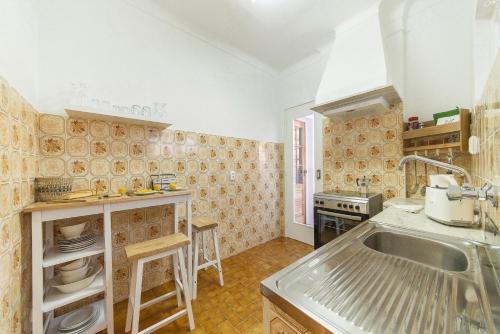 a kitchen with a sink and a stove at Abrotea Apartments in Lagos