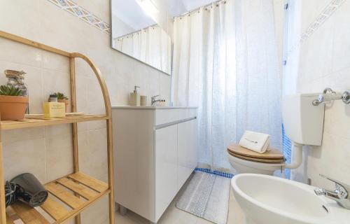 a bathroom with a toilet and a sink at Abrotea Apartments in Lagos