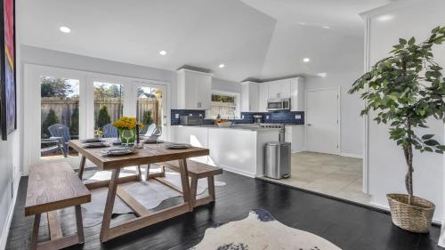 a kitchen with a table and a dining room at Modern Villa Retreat in Historic College Park in Atlanta