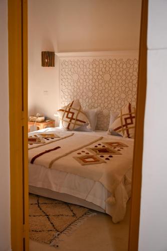 a bedroom with a large bed and a mirror at Riad Dar Fena By K&G &jacuzzi in Marrakesh