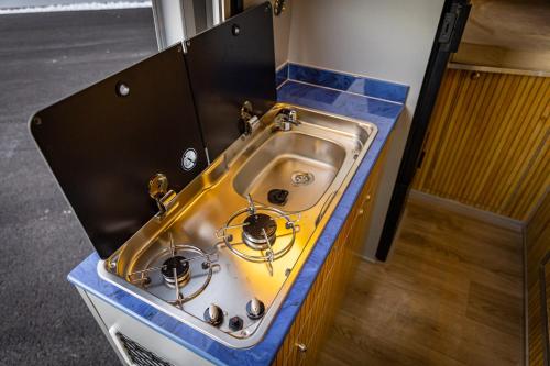a kitchen counter with a sink in a kitchen at Gogo vans home on wheels in Kriva Palanka