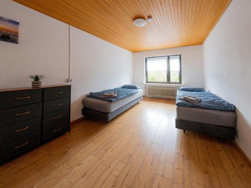 a room with two beds and a dresser in it at Bremen Farge Wohnung mit 6 Schlafplätzen 