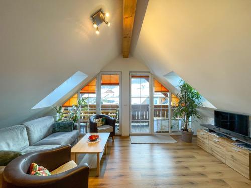 a living room with a couch and a tv at Penthouse Aineckblick in Sankt Margarethen im Lungau