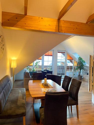 a dining room with a table and chairs at Penthouse Aineckblick in Sankt Margarethen im Lungau