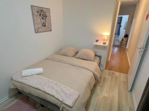 a small bed in a small room with a hallway at Chambre City - Colocation - Métro 8 - RER 5 min in Créteil