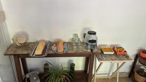 a table with plates of food and drinks on it at Apart Hosteria Plaza-La Cumbre in La Cumbre