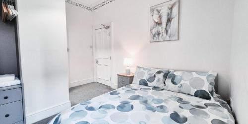 a bedroom with a bed in a white room at The Burford Hideaway in Nottingham