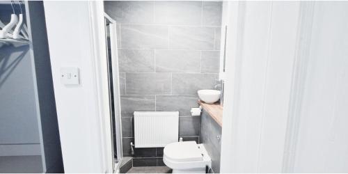 a bathroom with a white toilet and a sink at The Burford Hideaway in Nottingham