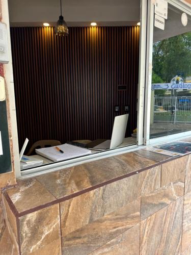 a desk with a laptop sitting on top of a window at Bungalows villas belen in Cedro