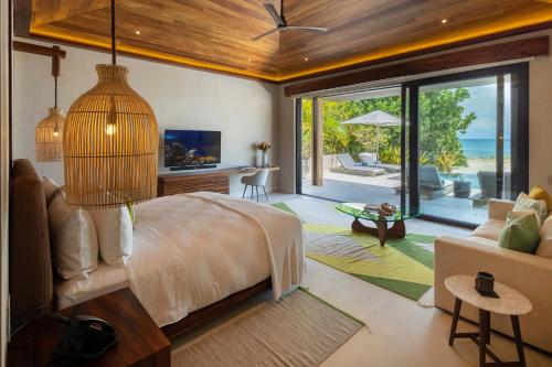 a bedroom with a bed and a view of the ocean at Beachfront Villa with Butler and Private Pool in Punta Mita