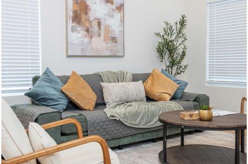 a living room with a couch with pillows on it at 5BR3BA Minutes from the Action with Skyline Views in San Antonio