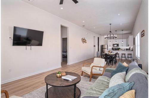 a living room with a couch and a table at 5BR3BA Minutes from the Action with Skyline Views in San Antonio