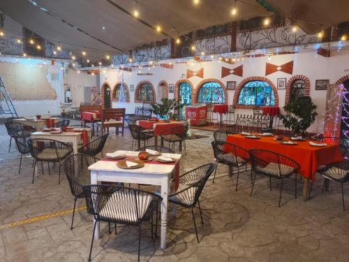 a restaurant with tables and chairs and christmas lights at HOTEL PALACIO CHATINO in Santos Reyes Nopala