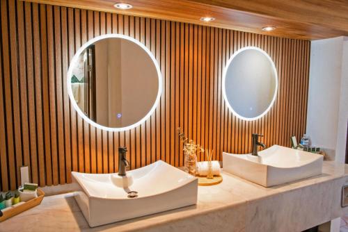 ein Badezimmer mit zwei Waschbecken und zwei Spiegeln in der Unterkunft HOTEL SAN CARLOS PLAZA in San Carlos